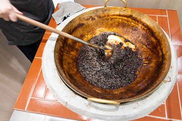 Worker preparing tapioca pearl balls into bubble or boba tea