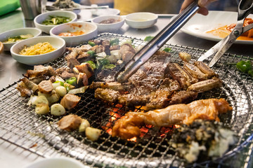 Closeup of Korean barbecue being grilled on hot charcoal stove