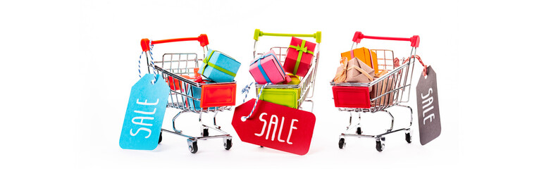 decorative small shopping carts with gift boxes and price tags with sale lettering isolated on...