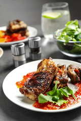 Delicious grilled ribs served on grey table