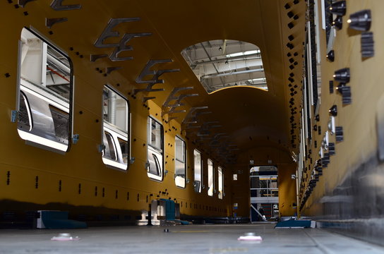 Inside of the rail car assembly plant. Industrial workshop for the production of high speed trains. Factory of the manufacturing trainsets passenger rolling stock. Paint shop. Small sharpness.