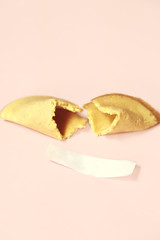 fortune cookie on pastel pink background