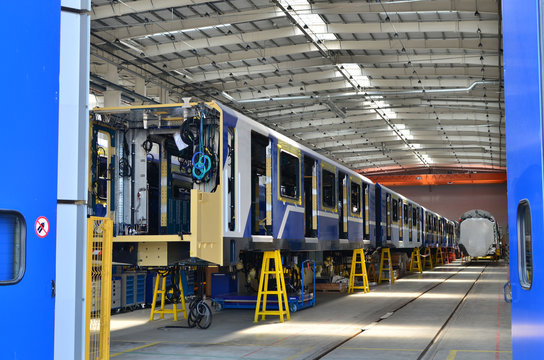 Inside of the rail car assembly plant. Industrial workshop for the production of European high speed trains. Factory of the manufacturing trainsets rolling stock for subway - Image