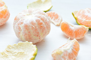  Natural, whole, chopped tangerines on wooden background