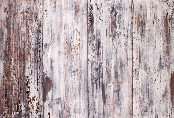 Texture of old painted boards with cracked and peeling white paint