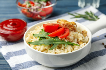 Delicious chicken risotto served in bowl on table