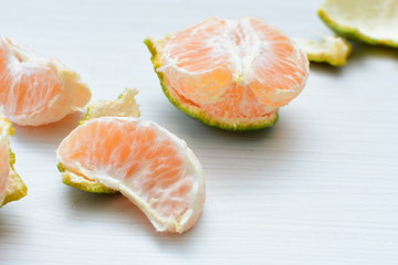  Natural, whole, chopped tangerines on wooden background