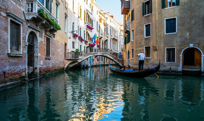Fototapeta na wymiar View of the canal with gondolas and old buildings in Venice, Italy. Venice is a popular tourist destination of Europe. Vacation and holidays in Italy and Europe concept.