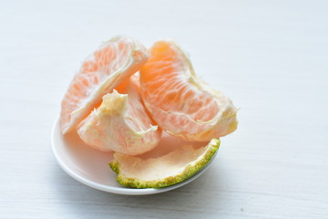  Natural, whole, chopped tangerines on wooden background
