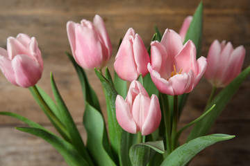 Beautiful pink spring tulips on wooden background, closeup