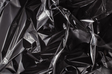 Background texture of a polyethylene transparent film on a black background