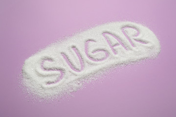 Composition with word SUGAR on lilac background