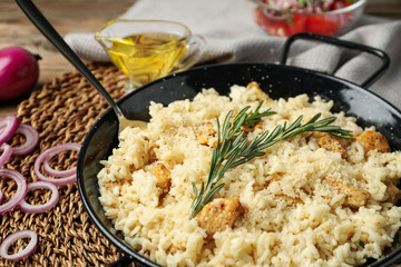 Delicious chicken risotto served on table, closeup