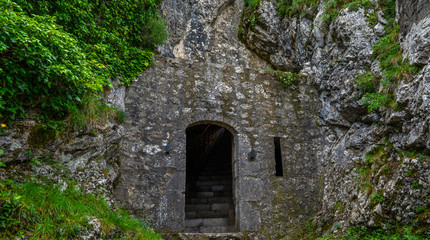 Exterior of the entrance to the citadel of Sisteron, rock fortress in the south of France, Europe. Listed as UNESCO World Heritage Site. Stone wall with traces of weathering and destruction.
