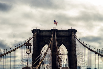 Details of the Brooklyn Bridge in New York City, USA. Toned image with sun light leak