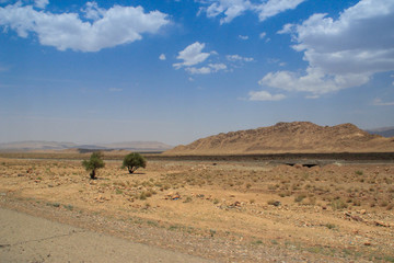 Desert landscape with rocks and geological formations on a hot summer day on the road from Kerman to Mashhad.