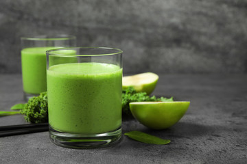 Tasty fresh kale smoothie on grey table