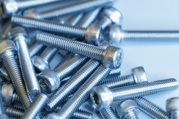 Set of screws close up. Macro photo of screws on a white background. Macro photo chromed screws, screw background, steel screw, selective focus.