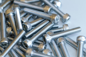 Set of screws close up. Macro photo of screws on a white background. Macro photo chromed screws, screw background, steel screw, selective focus.