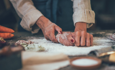 Process of making homemade pasta. Chef make fresh italian traditional pasta. Tasty appetizing classic italian pasta with tomato sauce, cheese parmesan, basil and vegetables on dark table.