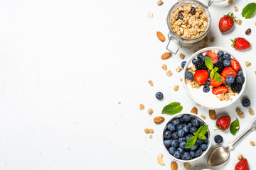 Greek yogurt granola with fresh berries on white table. - Powered by Adobe