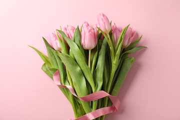 Bouquet of tulips on pink background. Holiday flowers background