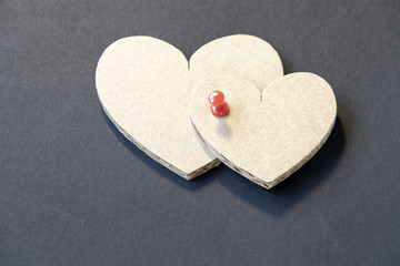 Fototapeta premium Valentine's day cardboard hearts on a dark background