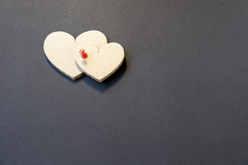 Valentine's day cardboard hearts on a dark background