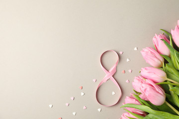 Pink tulips, candies in heart shape and 8 on grey background, space for text