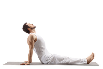 Man on a floor mat doing a yoga stretch