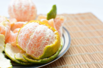  Natural, whole, chopped tangerines on wooden background
