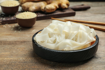 Tasty rice noodles on wooden table, closeup