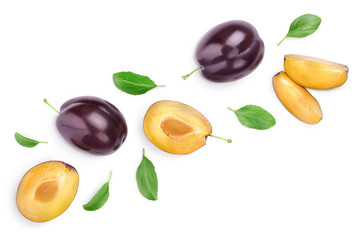 fresh purple plum and half with leaves isolated on white background with clipping path and copy spase for your text. Top view. Flat lay