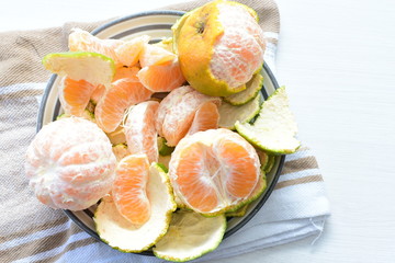 Natural, whole, chopped tangerines on wooden background