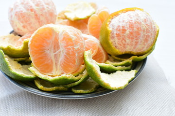  Natural, whole, chopped tangerines on wooden background