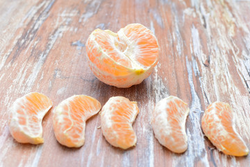  Natural, whole, chopped tangerines on wooden background