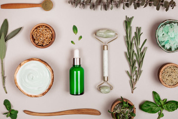 Modern cosmetics accessoires and ingredients on grey background. Flat lay style.