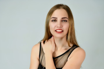 Naklejka premium A close-up portrait of a pretty Caucasian model with excellent facial skin and good makeup on a white background. Cosmetics concept, facial skin care.