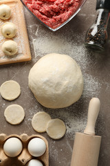 Composition with spices, minced meat and dumplings on grey background, top view
