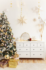 Concept of Christmas decoration for the house, horse on the background of a Christmas tree, bokeh, garlands, white chest of drawers, children's room with toys and gifts, living room interior.