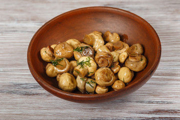 Clay bowl with pickled mushrooms