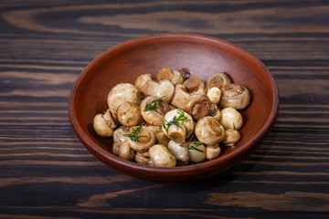 Clay bowl with pickled mushrooms