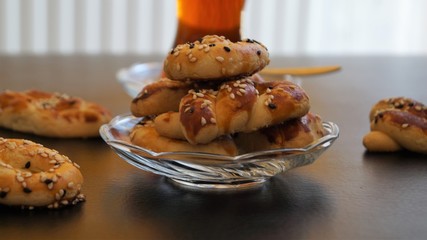 traditional turkish cookies - kurabye and tea in a glass cup on a black table