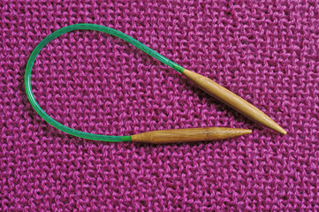 circular knitting needles lie next to the beaches.