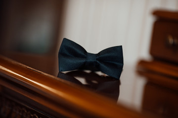 Wedding. Details. Bow tie on wooden texture. Groom butterfly tie on wooden surface