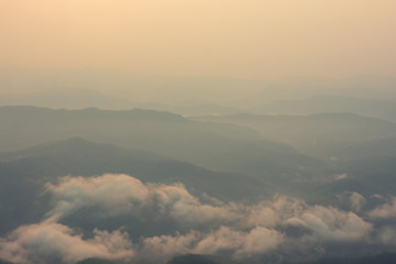 Sunrise among mountains and fog