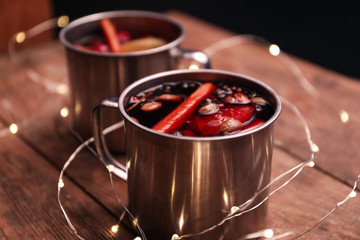 Tasty aromatic mulled wine on wooden table