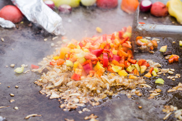 Grilled vegetables on the table. Fried vegetables in a metal stand at the fair.