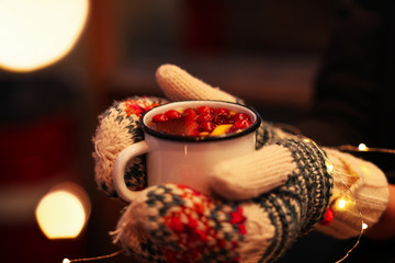 Woman with mulled wine at winter fair, closeup