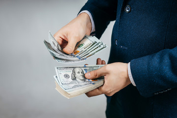 Businessman counts real money in hands